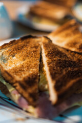 triangular-shaped sandwich plate with toasted bread, artistic light, night. vertical photo