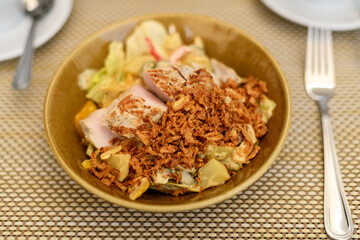 Plate salad fried onion chips on the table .