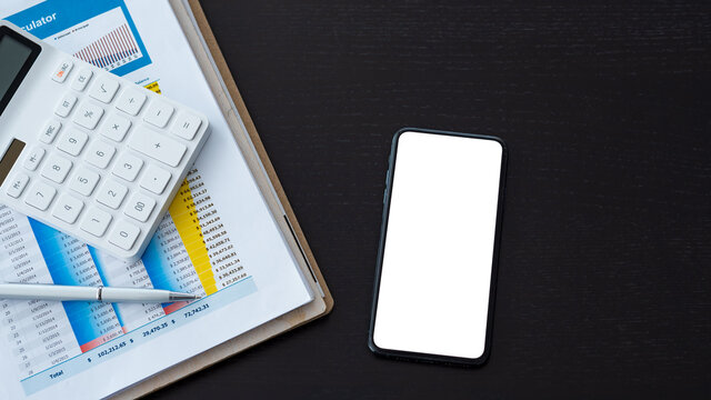 Workspace with a smartphone a blank white screen is accounting documents are placed on wooden table. Mock up.