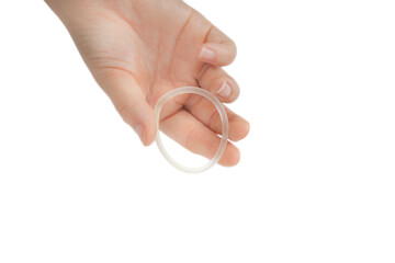 Birth control ,hormone, contraception ring in a womans hand isolated on white background, vaginal...