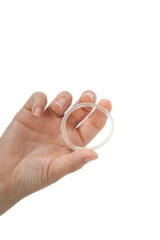 Birth control ,hormone, contraception ring in a womans hand isolated on white background, vaginal ring for contraceptive use with copy space