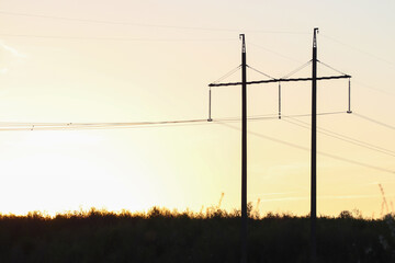 High-voltage power line at sunset.