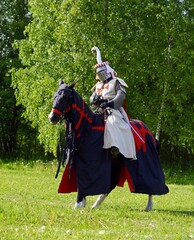 Knight in armor on a horse. Horse rider. Knight Templar. Knight Tournament. Belarus