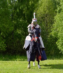 Knight in armor on a horse. Horse rider. Knight Templar. Knight Tournament. Belarus