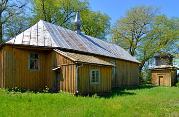 The belfry, turret and general view of the wooden Catholic church of the Exaltation of the Holy Cross in the town of Seroczyn. A new brick church has been operating since 1993, the wooden one is deter