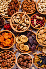 Various Nuts and dried fruits in wooden bowls.