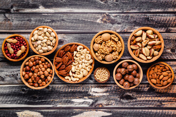 Various Nuts in wooden bowls.