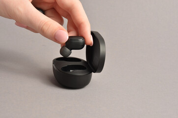 Wireless headphones on a gray background.