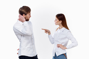 a woman in a shirt gestures with her hands and looks at a young man employees partners