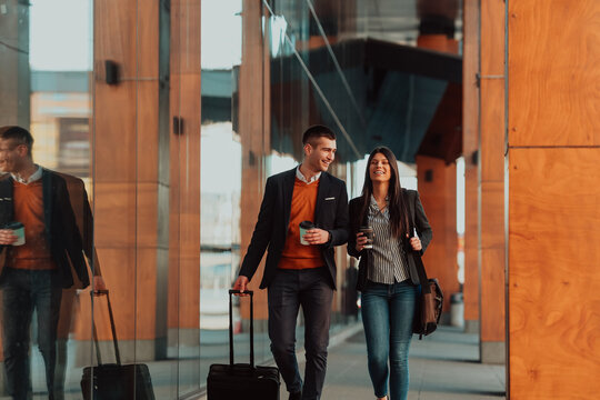 Two businessmen walk around town drinking coffee