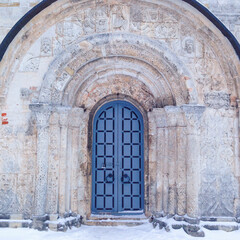 Fototapeta na wymiar Old gate of monastery in winter