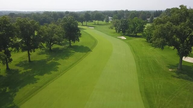 Aerial push in of golf course fairway