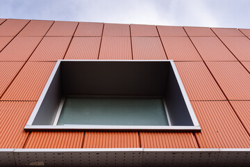 Detail of window with aluminum frame in ceramic ventilated facade. Perforated Steel Angle in the base. Thermal and acoustic isolation