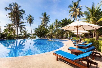 Fototapeta na wymiar Beautiful tropical beach front hotel resort with swimming pool, sunshine, summer holidays vacation