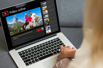 Obraz na płótnie Canvas Woman watching videos online on laptop