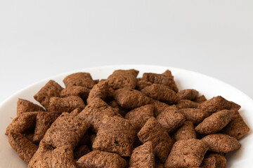 bowl with chocolate corn pads isolated on white background, cereals breakfast