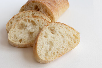 slice of ciabatta bread isolated on white background, side view