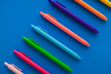 Multicolored Pens on Blue Background
