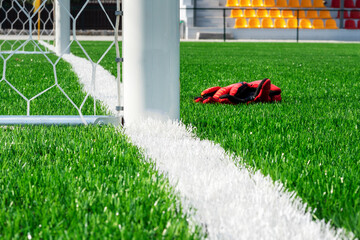 Grid of a football goal. A look with a side. Goalkeeper gloves at the football goal.