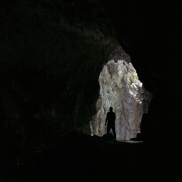 Silhouette of a person inside the cave