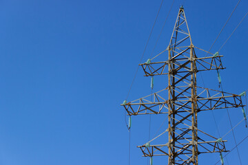 Electric transmission line with steel wires stretched against sky