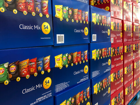 BAXTER, MN - 3 FEB 2021: Store display of blue boxes with bags of snacks and edible chips for sale. A Classic Mix of six bags of Lays brand chips in bags.