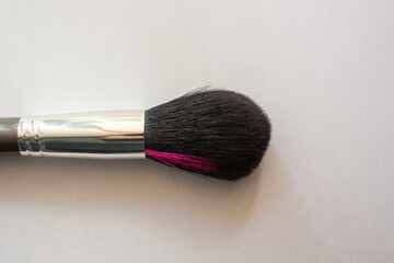 Cosmetic brush on a white background. Beauty accessories. Makeup artist tools