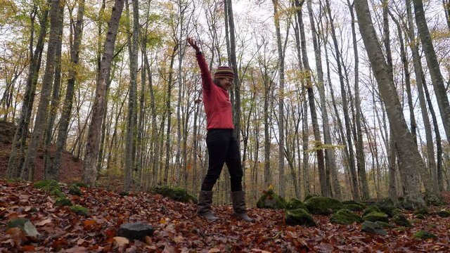 Woman throwing dry leaves to the wind in a forest in Autumn.Happy girl throwing leaves in the wind and spinning in slow motion action.
Beech field in early autumn.
Natural landscape of La Fageda in 