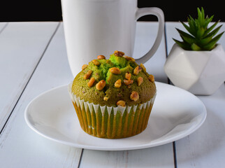 pistachio muffin with a cup of coffee - Powered by Adobe