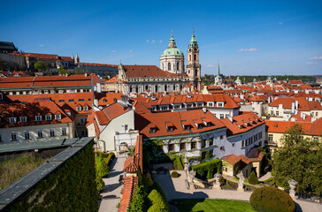 Fototapeta na wymiar View from Vrtbovska garden to red roof of Prague Lesser town, St. Nicholas curch and complex of Prague castle