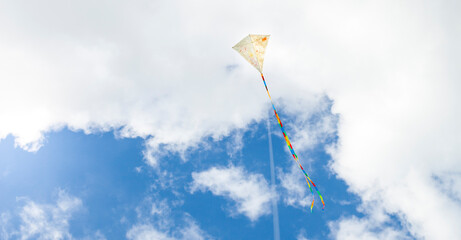 Self-painted kite flies against a blue sky. Creatively painted kite. Kite flying. Selbst bemalter...