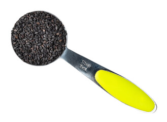 black sesame seeds in steel measuring spoon cutout