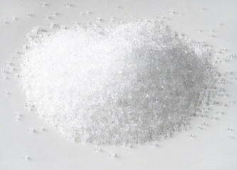 handful of fructose crystalline sugar on white