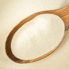 raw manna croup in wooden spoon closeup