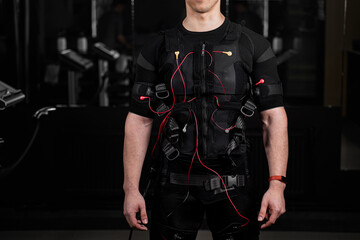 Naklejka premium EMS suit with red wires for electro impulse stimulation for body. Training in GYM.