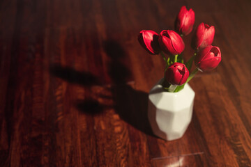 red tulips on wooden background
