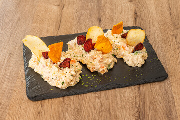 Large top of Russian salad with french fries and sweet potatoes