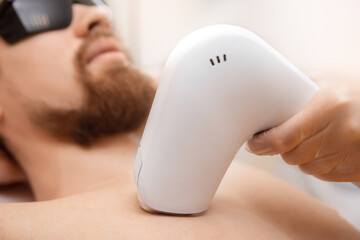 Closeup man torso hair removal laser epilation studio