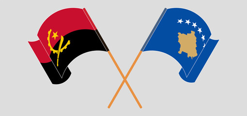 Crossed and waving flags of Angola and Kosovo