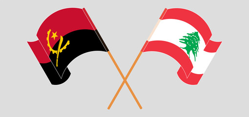Crossed and waving flags of Angola and the Lebanon