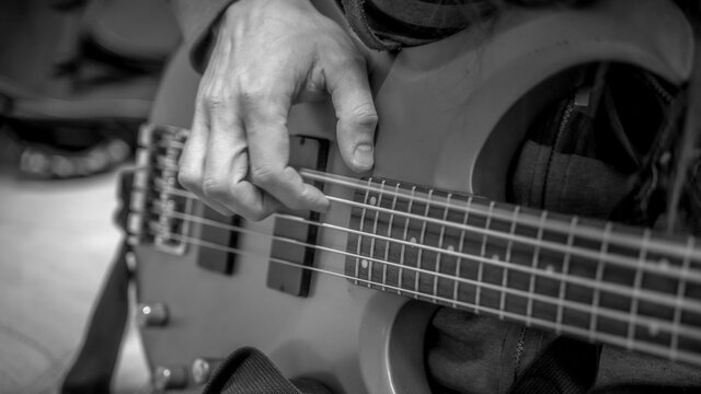 musician playing guitar black and white image, close up