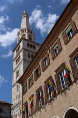 Fototapeta na wymiar Modena, Italy, Ghirlandinna tower and municipal palace with flags, Unesco world heritage site