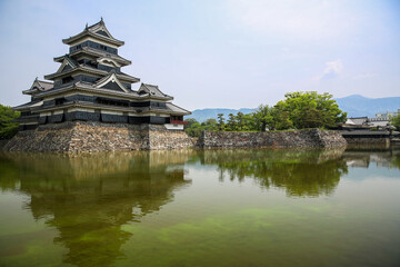 Fototapeta na wymiar Matsumoto Castle, known as The Crow Castle surrounded by a green water moat, Matsumoto, Japan.