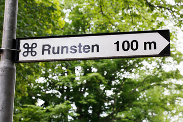 Signpost for a Swedish runestone heritage object 100 m distance.