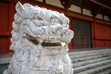 Stone marble Lion dog statue in Sensoji Temple, a Japanese Buddhist Temple in Asakusa, Tokyo, Japan.