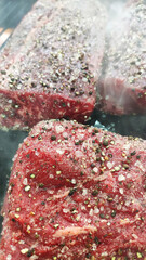 raw meat with seasoning on the grill