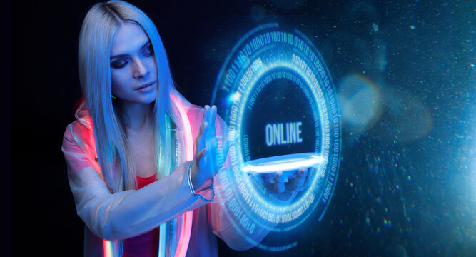 Woman with futuristic tablet in hand. Girl in glasses of virtual reality presses the start button. Augmented reality game, future technology, AI concept. Holographic interface to display data.