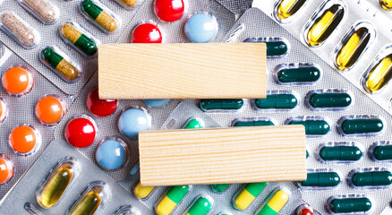 On a background of tablets of different colors, wooden blank blocks with a place to insert text....