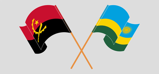 Crossed and waving flags of Angola and Rwanda