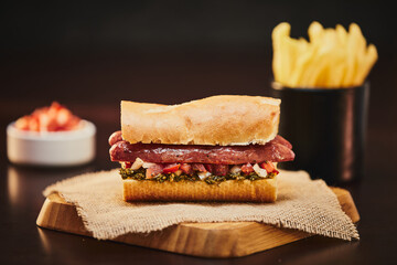 Argentinian choripan with chimichurri and creole sauce.